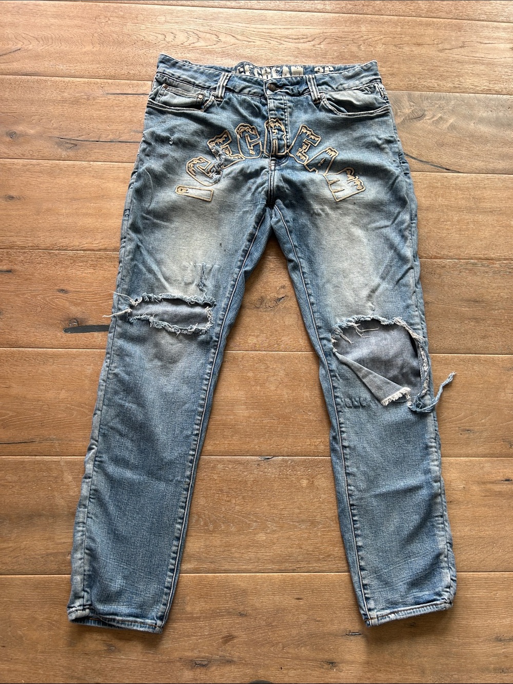 Distressed Light Blue Jeans with Front Lettering